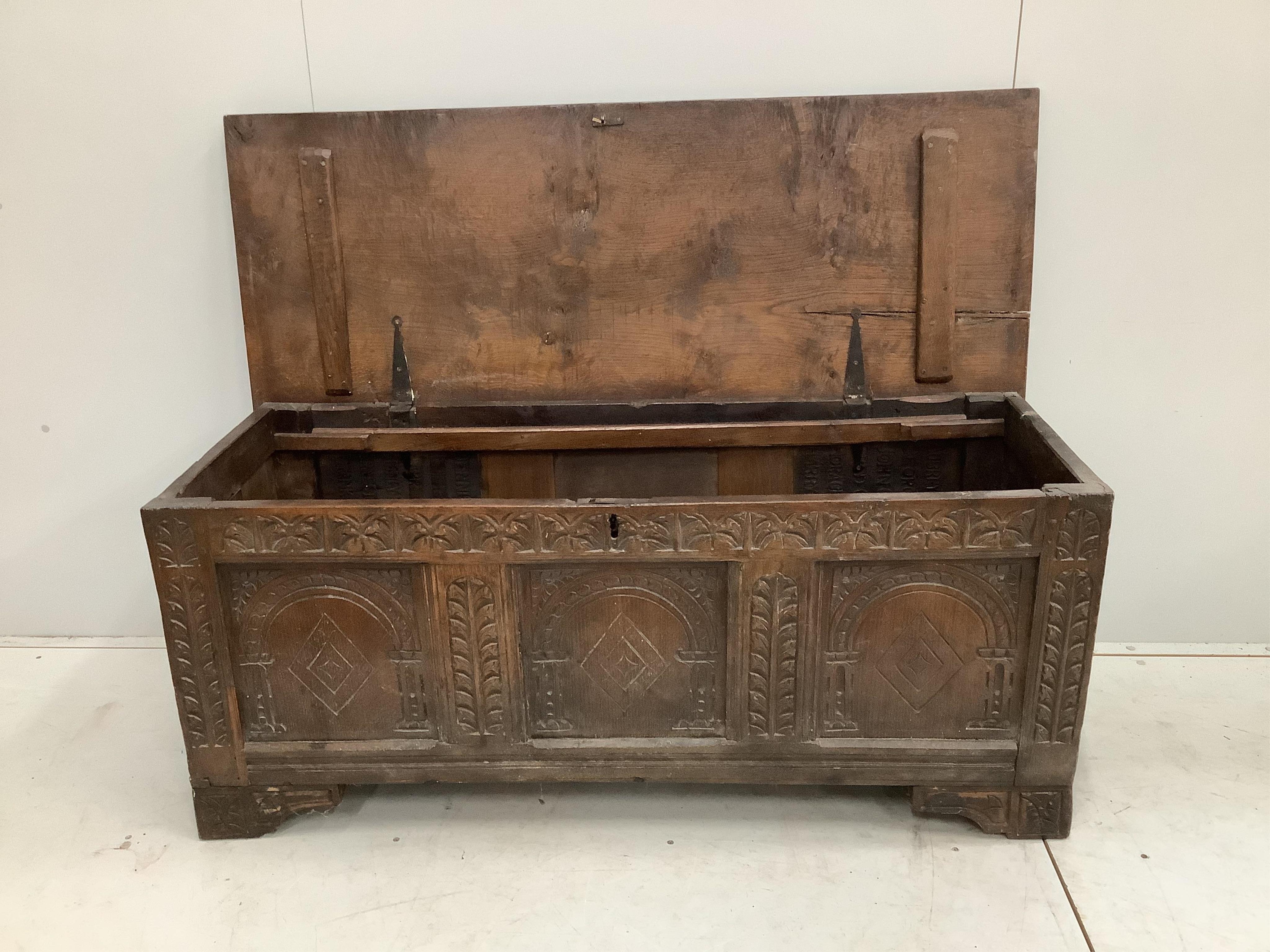 An 18th century carved oak coffer, width 140cm, depth 53cm, height 59cm